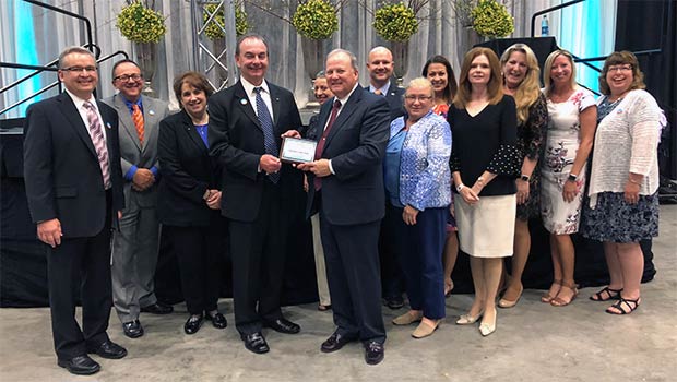 Diamond Credit Union board members and staff pose with award for Top 50 business