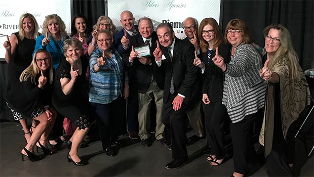 Diamond Credit Union board members and staff pose with the award for Top 50 business