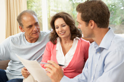 financial advisor meeting with older couple