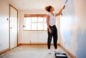 woman painting in new home budget