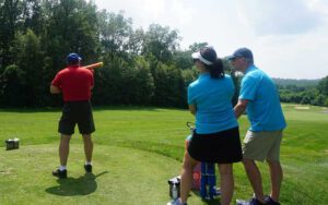 A person shooting off the golf ball cannon at the charity golf tournament.