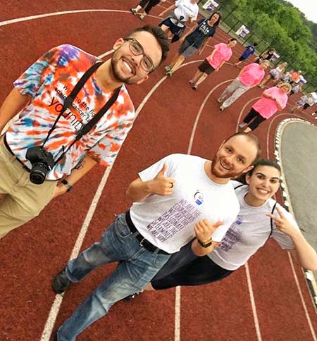Anthony H., Peter D., and others walking around a school track for Relay for Life.