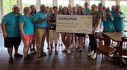 Diamond presenting a giant check for $47,000 to the American Cancer Society after the golf invitational.