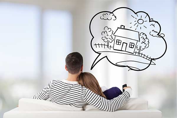 A man and woman dreaming of one day owning their own home.