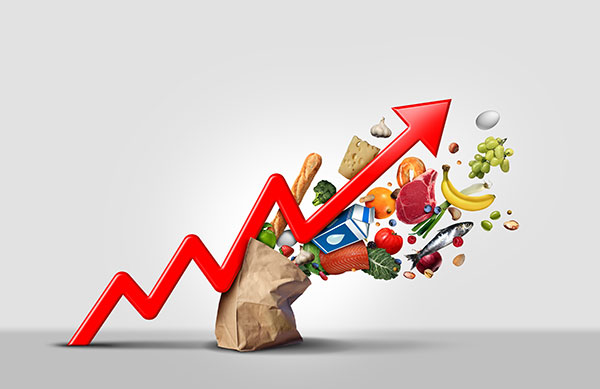 An arrow over a bag of groceries showing inflation and the cost increasing.