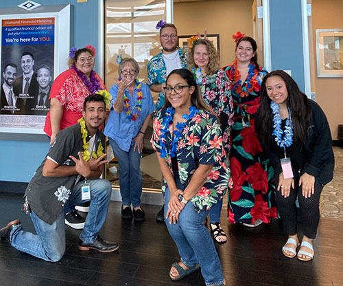 8 Diamond employees wearing Hawaiian attire for Aloha Friday.