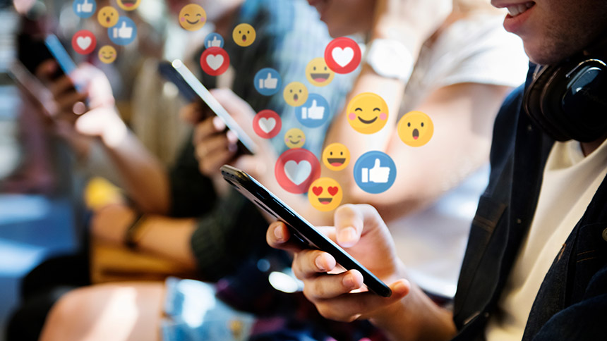 Social Media reactions hovering overtop of mobile devices.