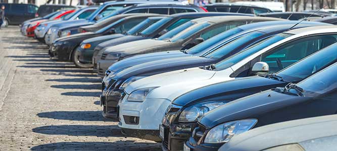 A row of used cars on a lot.