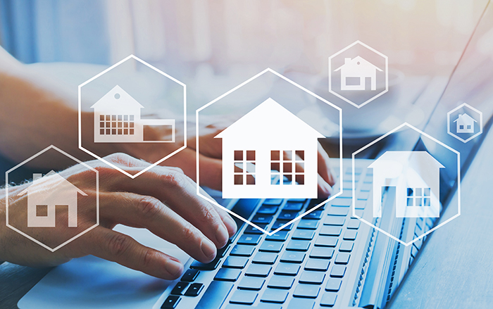 Holographic image above a laptop, depicting how to decide on a mortgage loan.
