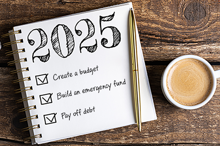 white notebook with words "2025" at top and check list with words "Create a budget," "Build and emergency fund," and "pay off debt." Gold pen on top with a cup of coffee to the right.