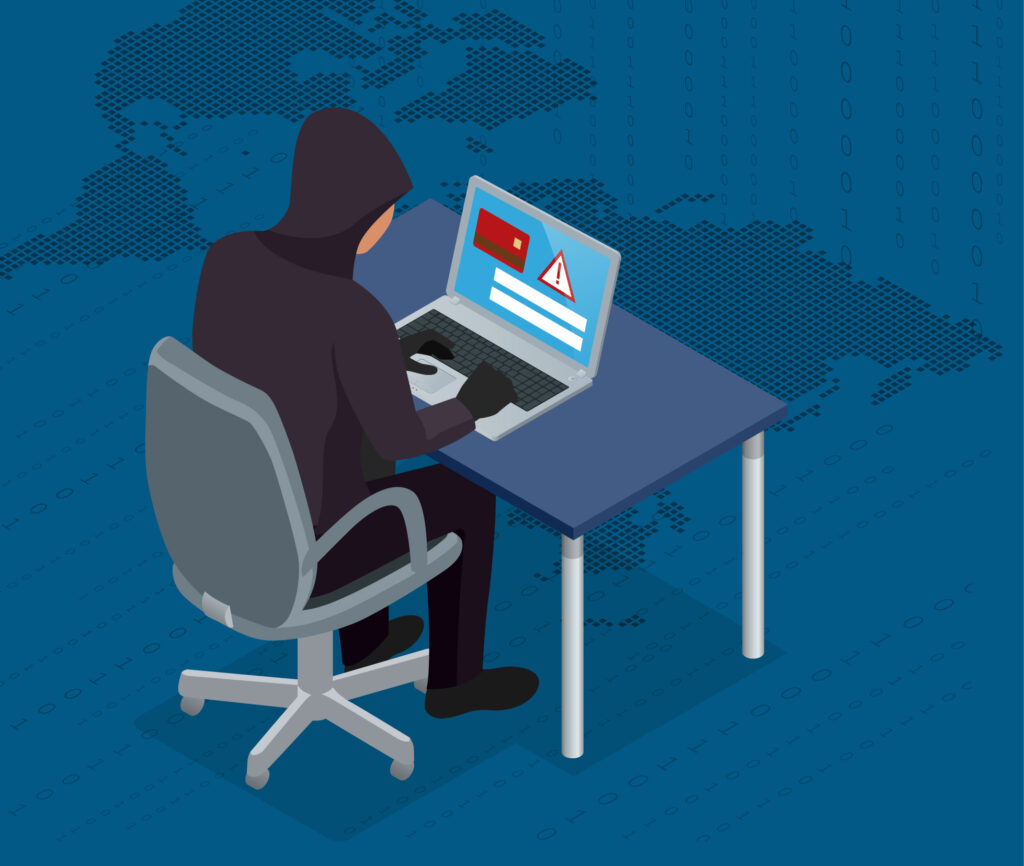 A cartoon graphic of a computer hacker at a table hacking into a laptop.